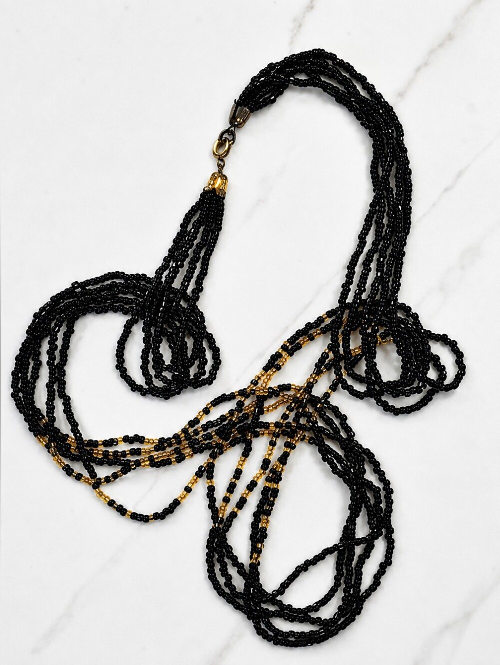 Multi-Strand Black and Gold Beaded Necklace.